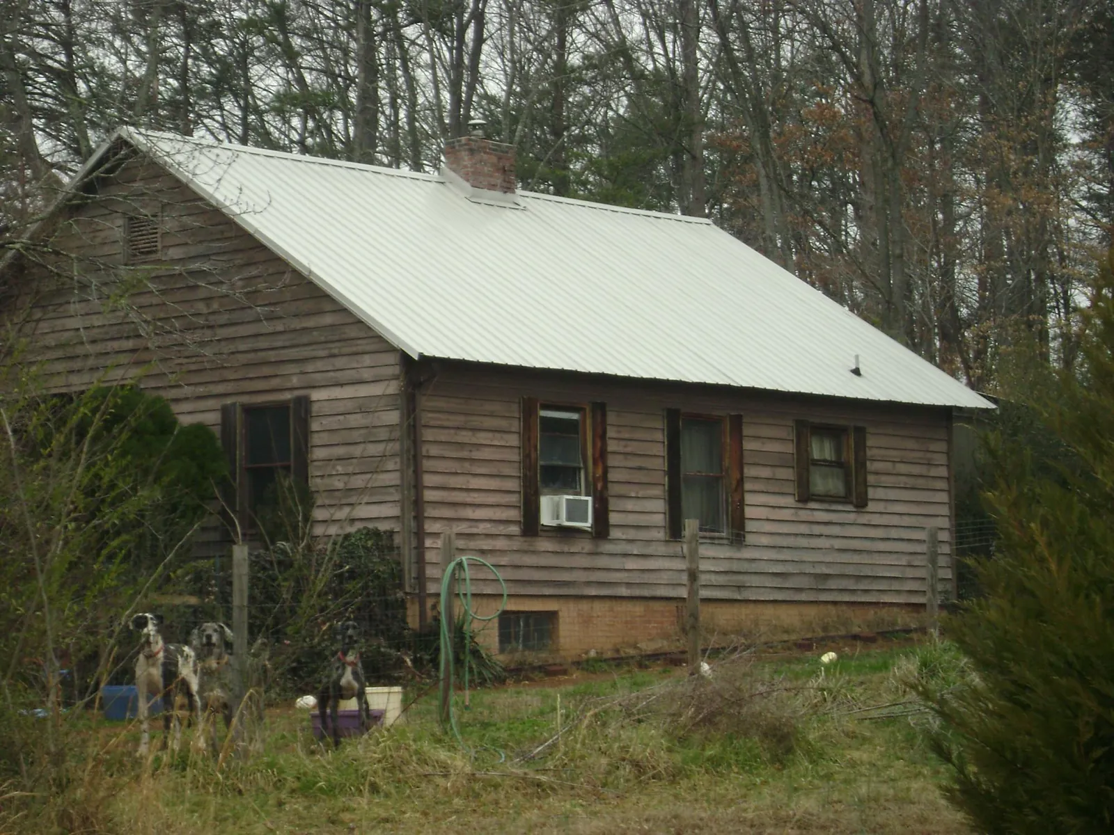 White metal roof on an old wood sided farmhouse, from a Metal Roof Installation job in Wrentham